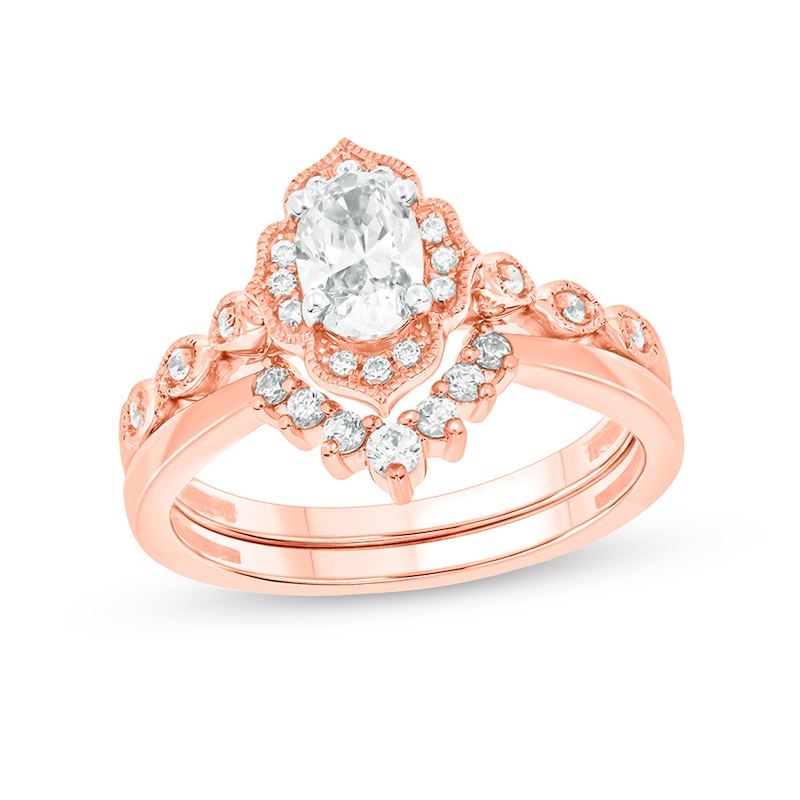3/4 CT. T.W. Oval Diamond Frame Vintage-Style Bridal Set in 14K Rose Gold (I/I2)